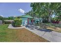 Exterior of a one story home featuring an attached garage and nice landscaping at 2212 Portside Psge, Palm Harbor, FL 34685