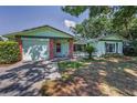 Charming single-story home featuring a brick facade, attached garage, and mature landscaping at 2212 Portside Psge, Palm Harbor, FL 34685
