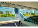 A view of the stairs leading to the building with parking spot and lush greenery surrounding the building at 255 114Th N Ave # 4, St Petersburg, FL 33716