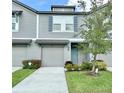Charming two-story townhome featuring an attached garage and well-maintained landscaping at 2717 Chestnut Creek Pl, Brandon, FL 33510