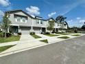 Beautiful exterior view of well-maintained townhomes, each with a private driveway and manicured lawn at 2717 Chestnut Creek Pl, Brandon, FL 33510