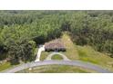 Expansive aerial shot revealing the property's layout, ample land, circular driveway, and harmonious integration with nature at 27338 Elkwood Cir, Wesley Chapel, FL 33544