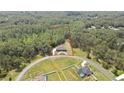 Aerial view showcasing this luxury home surrounded by lush greenery, highlighting the property's privacy and serene setting at 27338 Elkwood Cir, Wesley Chapel, FL 33544