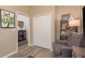 Cozy den with comfortable seating, neutral tones, and a view into the foyer at 2747 Wood Pointe Dr, Holiday, FL 34691