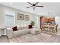 Bright and spacious living room featuring hardwood floors, a ceiling fan, and stylish decor at 3095 Riders Pass, Odessa, FL 33556