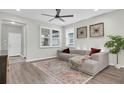 Comfortable living room with hardwood floors, modern furniture, and ample natural light at 3095 Riders Pass, Odessa, FL 33556