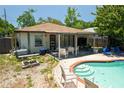 Outdoor pool featuring a patio with white furniture and a grill at 3139 W Varn Ave, Tampa, FL 33611