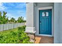 This home welcomes you with a gorgeous blue front door and a beautiful stone and tiled porch at 3228 Bryant Park Dr, New Port Richey, FL 34655