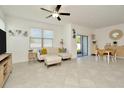 Bright, open-concept living room with modern furnishings, tile flooring, and lots of natural light at 3228 Bryant Park Dr, New Port Richey, FL 34655