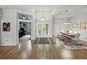 Bright, expansive foyer with double front doors, wood-look tile flooring, and views into the dining room at 3909 Valrico Grove Dr, Valrico, FL 33594