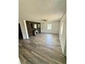 Cozy living room featuring stylish wood-look flooring, a ceiling fan, and a decorative fireplace at 439 Corbett Rd, Lithia, FL 33547