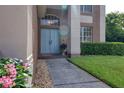 Charming home entrance featuring double doors, stone walkway and beautiful landscaping at 4750 Augusta Ave, Oldsmar, FL 34677