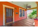 Inviting front porch with ceiling fan, wood floors, and craftsman style door at 506 S Melville Ave, Tampa, FL 33606