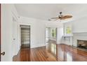 Bright living room featuring hardwood floors, fireplace, and built-in shelving at 506 S Melville Ave, Tampa, FL 33606