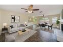 Open concept living and dining area with fireplace, stylish furnishings, and tile flooring at 521 E Lumsden Rd, Brandon, FL 33511