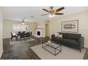Inviting living room and dining area with modern decor, fireplace, and sliding glass doors to the backyard at 521 E Lumsden Rd, Brandon, FL 33511