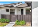 Welcoming front porch with a brown privacy fence, secure front entry and manicured landscaping at 5306 Marlwood Ct, Tampa, FL 33624