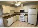 Functional kitchen featuring white appliances, a microwave, and ample cabinet space at 6102 Massachusetts Ave, New Port Richey, FL 34653