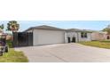 Spacious driveway leading to a two-car garage with stylish, modern privacy fencing at 6240 Keller Dr, Port Richey, FL 34668