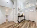 Welcoming foyer with high ceilings, wood-look tile flooring, and an elegant console table at 66 Bay Woods Dr, Safety Harbor, FL 34695