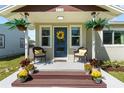Inviting front porch with charming decor, seating, and potted plants, perfect for relaxing outdoors at 715 39Th Ne Ave, St Petersburg, FL 33703