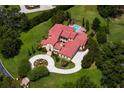 Expansive estate with a pool, lush lawns, mature trees, and a circular driveway at 7713 Still Lakes Dr, Odessa, FL 33556
