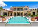 Luxury home featuring a pristine pool, spa, covered patio, and well-manicured garden at 7713 Still Lakes Dr, Odessa, FL 33556