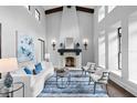 Inviting living room with soaring ceilings, a fireplace, and elegant furnishings at 7713 Still Lakes Dr, Odessa, FL 33556