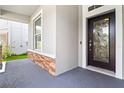 Inviting front porch with decorative brick accents and elegant front door with glass details at 7725 Tangle Rush Dr, Gibsonton, FL 33534