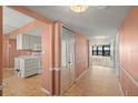 Welcoming hallway featuring tile floors, closet, and access to the kitchen and living area at 9415 Blind Pass Rd # 1201, St Pete Beach, FL 33706