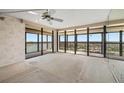 Bright living room with access to balcony offering panoramic water and city views at 9415 Blind Pass Rd # 1201, St Pete Beach, FL 33706