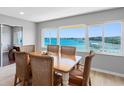 Bright dining room with scenic waterfront view, featuring a charming table and six chairs at 100 Bluff View Dr # 404C, Belleair Bluffs, FL 33770