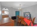Features a chandelier, wood table with six chairs and a vintage blue armoire at 10337 River Bream Dr, Riverview, FL 33569