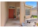 Inviting covered front porch with a vibrant red door and decorative landscaping at 10536 Shady Preserve Dr, Riverview, FL 33579
