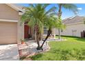 A cozy front yard with lovely landscaping and a charming entrance at 10536 Shady Preserve Dr, Riverview, FL 33579