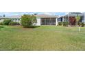 Spacious backyard with lush green lawn and screened in patio for outdoor enjoyment at 1130 Hominy Hill Dr, Trinity, FL 34655