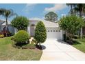 Charming single-story home featuring a well-manicured lawn and a two-car garage at 1130 Hominy Hill Dr, Trinity, FL 34655