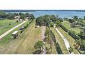 Aerial view of large lot with mature trees and expansive views of Lake Thonotosassa at 11337 Knights Griffin Rd, Thonotosassa, FL 33592