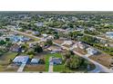 Aerial view showcases this neighborhood with lush greenery, single-Gathering homes, and serene streets at 11369 Gulfstream Blvd, Port Charlotte, FL 33981
