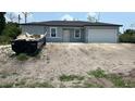 New construction home featuring a blank slate yard and two car garage, ready for customization at 11369 Gulfstream Blvd, Port Charlotte, FL 33981