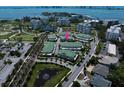 Aerial view of townhouses in a community with a golf course and waterfront access at 12 Country Club Ln, Belleair, FL 33756