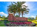 Attractive Bellevue Place & Inn sign with a lush flowerbed and mature palms at 12 Country Club Ln, Belleair, FL 33756