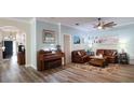 Cozy living room with beautiful hardwood floors, comfortable seating, and natural light streaming in at 12808 Killarney Ct, Odessa, FL 33556