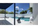 Relaxing backyard pool area featuring a spa, sun loungers, and privacy fencing at 14510 Mj Rd, Myakka City, FL 34251
