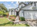 Inviting home featuring a well-manicured lawn and flower beds, offering a warm and welcoming entrance at 15202 Heathridge Dr, Tampa, FL 33625