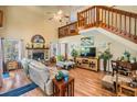 Spacious living room with a fireplace, wood floors, and a staircase leading to the second floor at 15202 Heathridge Dr, Tampa, FL 33625
