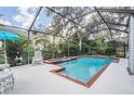Screened-in pool area with a sparkling blue pool and ample space for outdoor relaxation and entertaining at 15202 Heathridge Dr, Tampa, FL 33625