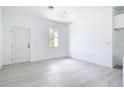 Bright living room featuring light wood-look flooring, fresh white paint and ample natural light at 16134 Libourn Ave, Port Charlotte, FL 33954