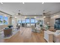 Bright and airy living room showcasing hardwood floors, stylish furniture, and sliding glass doors with ocean views at 2 Gulf Blvd, Indian Rocks Beach, FL 33785