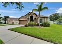 Beautiful one-story home with a lush, green lawn and meticulously landscaped front yard at 2330 Lawrence Hall St, Ruskin, FL 33570